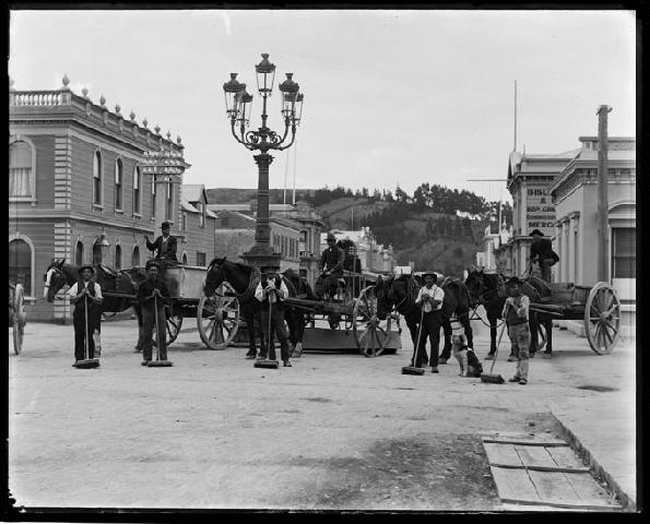 Nelson City Council, workers and carts.  View of a street cleaning gang on the c