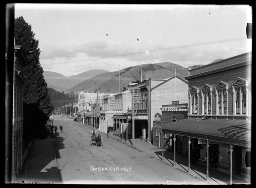  Looking along Hardy Street, Nelson. Showing (on right), Newman Brothers Crown Livery Stables; G F Dodds - dentist;The Wilkins and Field Hardware Company - ironmongers, 1911(?). 'Sir George Grey Special Collections, Auckland Libraries, 35-R858